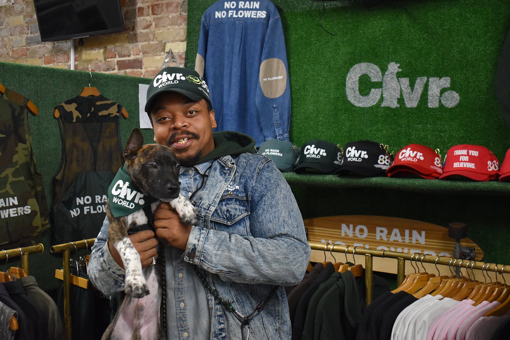 Entrepreneur Clarke Roosevellte holds one of his puppies within his retail space for the Clvr. World brand at 811 Retail; photo by Tommy Felts, Startland News
