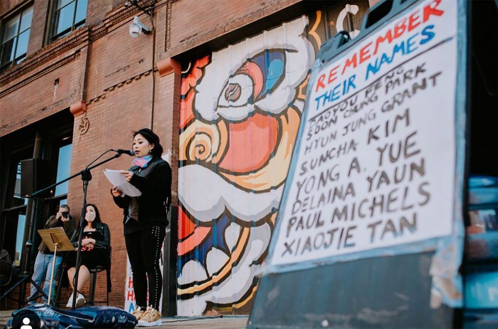 Jackie Nguyen speaks during a “Stop Asian Hate” vigil in March outside Firebrand Collective in the West Bottoms; Photo by Travis Young