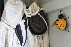 Bee suits hang in the corner of the shed for people to use while working or volunteering. Pierson said she is trying to find ways to get more people involved. One program the organization started in the past year is called “AmBEESadors.”