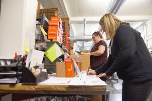 Wendy Jones and Lesley Moore pack FireBoard products ordered for the day at the company's Kansas City facilities