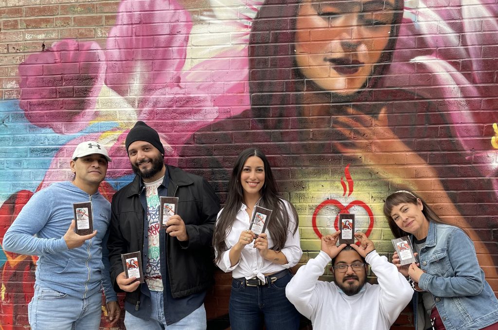 Curtis Herrera, co-owner of Café Corazón, muralist Isaac Tapia, Tyler Shane, muralist Rodrigo Alvarez, and Miel Herrera, co-owner of Café Corazón, outside the Westport business