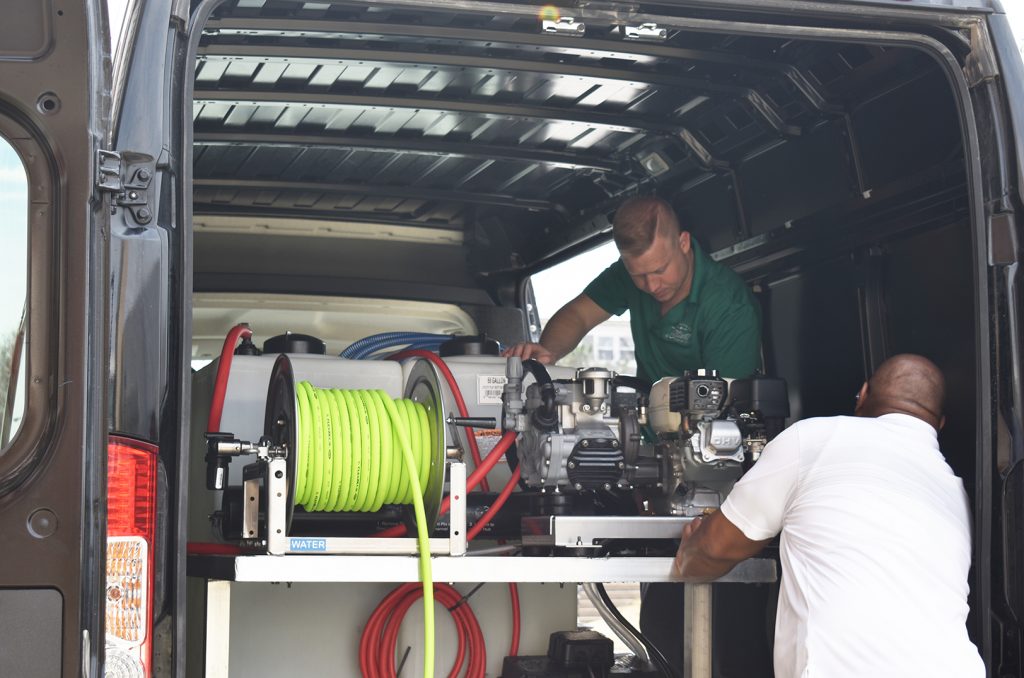 Andrew Brain and Leland Sanders prepare a Drone Wash cleaning drone