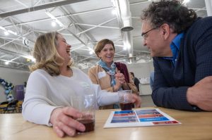 Natasha Kirsch, EPEC Inc, and Kristan Chamberlain, KC Can Compost, right, share a laugh Tuesday during a cohort announcement for the new LauchKC Social Venture Studio