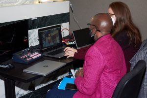 Entrepreneur Clarissa Knighten of Rissa's Artistic Design, learns about hybrid technology from Susan Monroe of the Greater Kansas City Chamber of Commerce