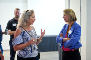 Rebecca MacKinnon, SoulFIRE Health, speaks with Erin Croom, of Atlanta-based Small Bites Adventure Club, at the NXTSTAGE Community Health and Vibrancy Pilot Competition